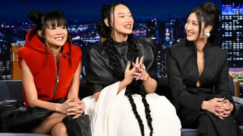 Getty Images Singers Rei Ami, Audrey Nuna, and Ejae of "KPop Demon Hunters" during an interview with host Jimmy Fallon on Tuesday, October 7, 2025