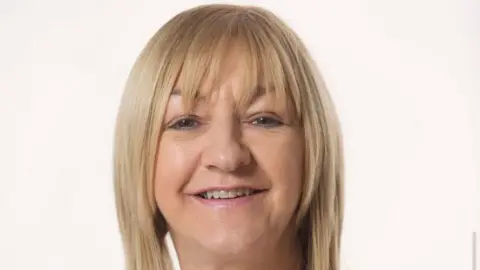 UTU Jacquie White who has long blonde hair with a fringe and is smiling into the camera