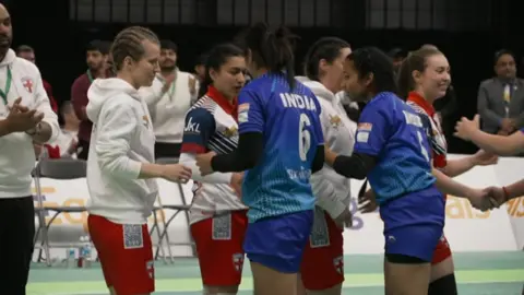 BBC India and England kabaddi players shake hands in a line after the final of the World Cup