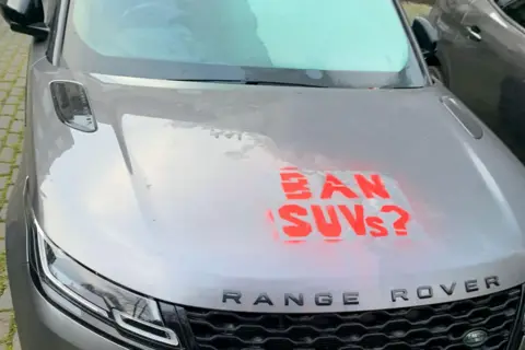 Range Rover with 'Ban SUVs' daubed on it.