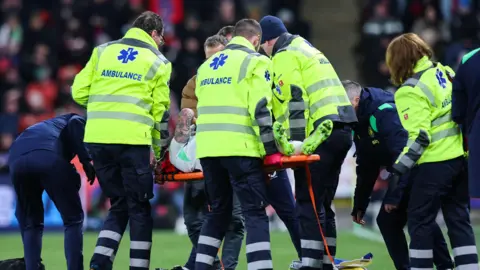Sammie Szmodics is stretchered off the pitch