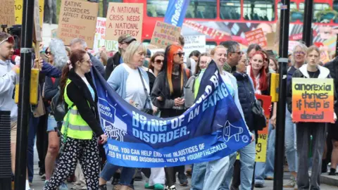 Karen Forsyth People gathered in central London holding placards about eating disorders