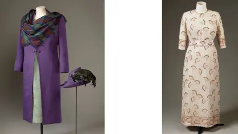 Royal Collection Enterprises Limited 2026/Royal Collection Trust/PA Wire Images of outfits worn by Queen Elizabeth II, onthe right a purple silk-wool coat, a green dress and a Isle of Skye tartan shawl and on the left a beaded silk evening gown.