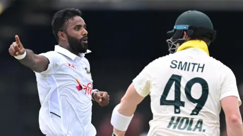 Bangladesh bowler Ebadot Hossain (left) appeals unsuccessfully for caught behind against Australia batter Steve Smith (right)