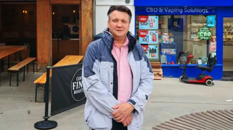 Dominic Cole from Heartfelt Care is standing outside his office in Yeovil.