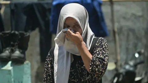 Getty Images A relative of a missing student mourns as rescuers search for survivors 