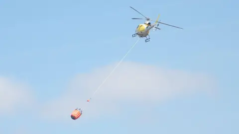 BBC Helicopter deploying water