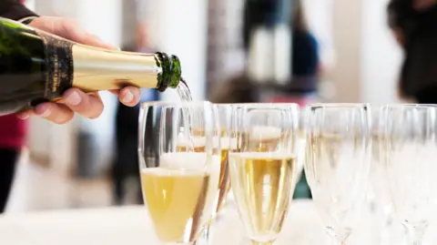 Getty Images Champagne being poured into glasses