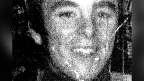 PA Media A damaged black and white image showing Peter Wilson. He has dark hair and is smiling, looking directly to camera.