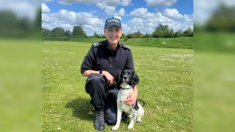 Wiltshire Police Dog handler Police Constable Emma Rice in police uniform with Reggie