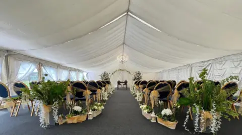 Leicestershire County Council A marquee set out as a wedding venue with chairs and flowers