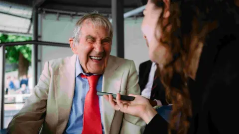 HRR Tony laughs as he is being interviewed.