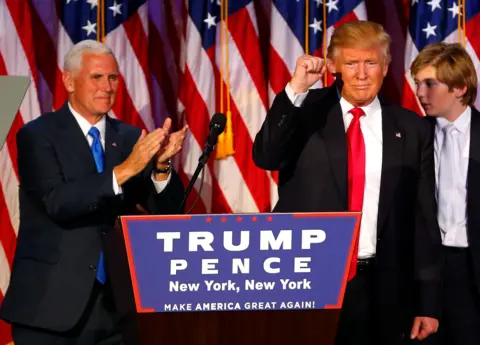 The Boston Globe via Getty Images  Donald Trump celebrates with his running mate Mike Pence, left, as he speaks to supporters at his election night event at the New York Hilton Midtown in New York City on Nov. 9, 2016. 