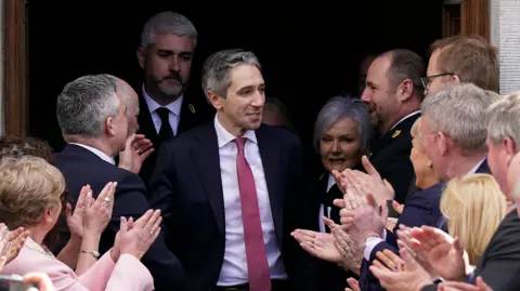  Niall Carson/PA Media Simon Harris was applauded as he left the Dáil after his election