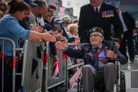 Christopher Furlong/Getty Images D-Day veterans are applauded in Arromanches-les-Bains, France