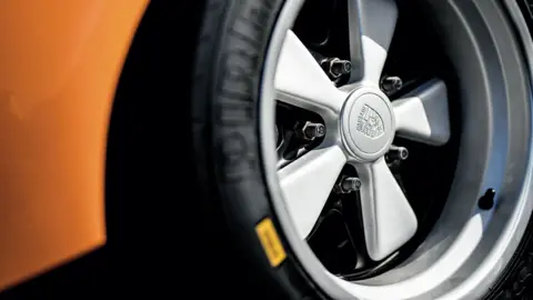 A close-up of a wheel of a sports car.