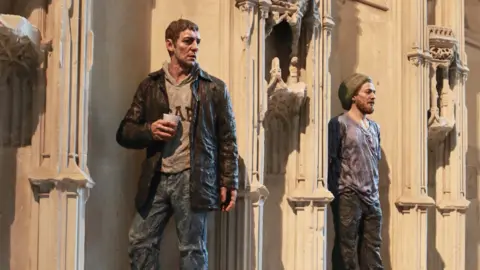 Sean Henry Two statues of men in casual attire