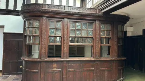Ben Parker/BBC An old wooden bar area is retained inside the building.