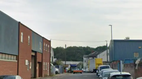 Street with vehicles at the end