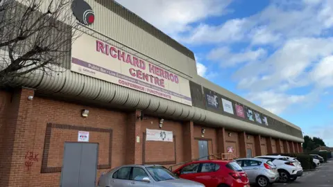 A building with the words 'Richard Herrod Centre' on the front 