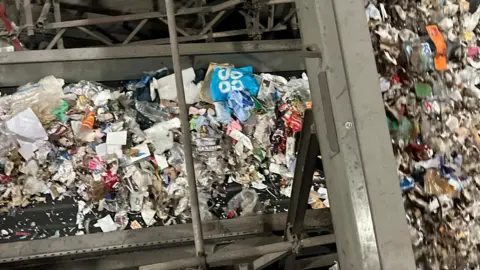 BBC Two conveyor belts of rubbish going one over the other