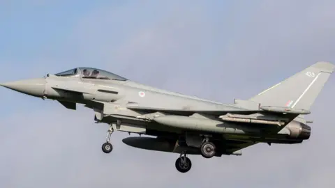 Jon Hobley/Getty Images Royal Air Force Eurofighter Typhoon coming into land at RAF Coningsby. It has the number 433 on the tail fin and the RAF's red, white and blue circular emblem behind the cockpit. 