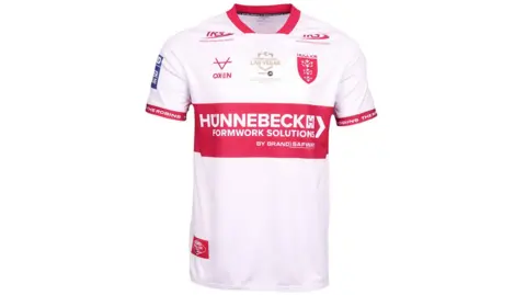 A red and white rugby league shirt on a white background. The shirt is mostly white with red trim around the collar and sleeves and a large red band around the centre. It features several sponsors' logos, a red Hull Kingston Rovers logo and a gold logo which says "Rugby League Las Vegas".