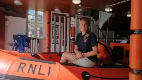 Anna Heslop sitting in an RNLI lifeboat