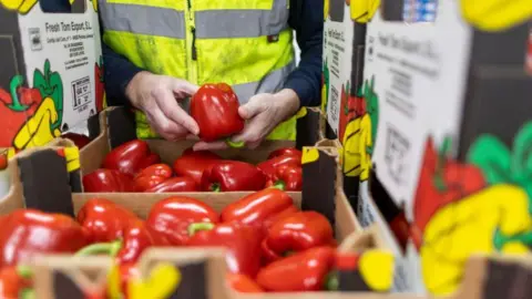 Getty images An employee checks boxes of red peppers imported from Spain at the D & F McCarthy Ltd. 