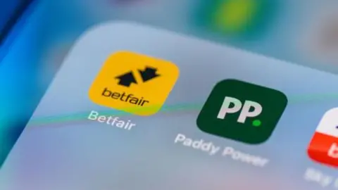 A phone screen with the Paddy Power and Betfair apps side by side in a folder