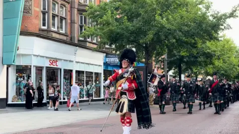 Pipers in kilts on High Street