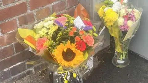 Tracey Williams Sunflower and an array of flowers on the street