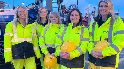 BBC Five female shore crew by the lifeboat