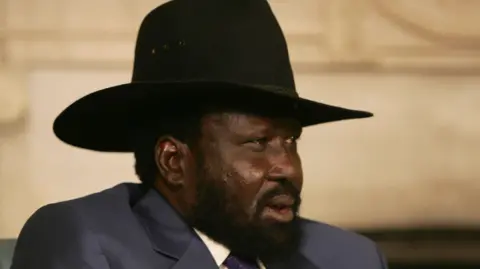 Salva Kiir, president of South Sudan, in a black hat