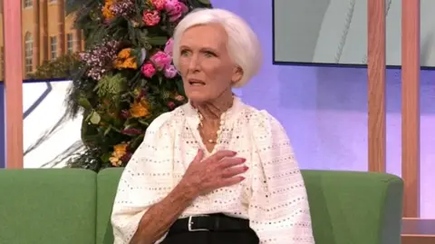 Dame Mary Berry with her hand on her chest