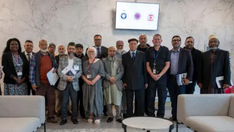 Office of the Police, Fire and Crime Commissioner A group of people including both men and woman. Some are Muslim leaders while the others include the PFCC, the Deputy Commissioner Marianne Kimani, and the Chief Constable.