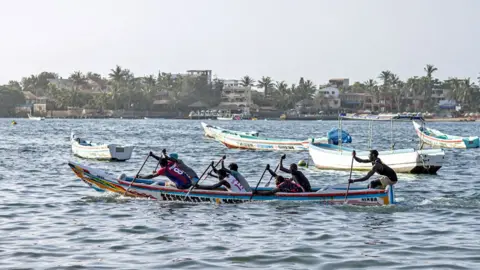 John Wessels/AFP Competitors race in a pirogue boat during at a cultural event at Ngor beach in Dakar, Senegal – Wednesday 5 June 2024