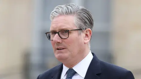 British Prime Minister Keir Starmer leaves after the multinational virtual summit and press conference at the Elysee Presidential Palace on April 17, 2026.