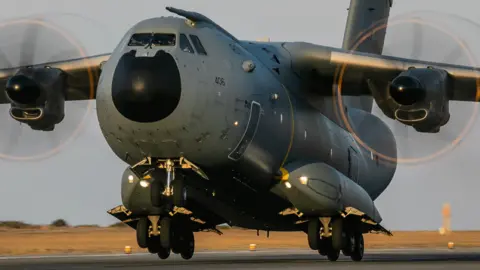 RAF The A400M takes off from a runway in a desert region.