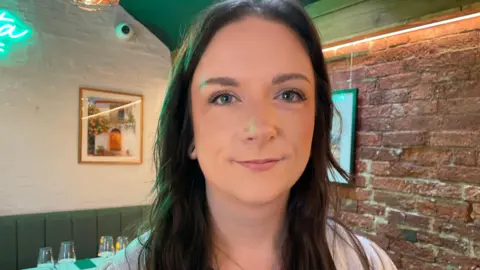 Young woman with long dark hair in a restaurant