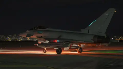 EPA/Shutterstock Nighttime shot of an RAF Typhoon fighter jet taxiing on a runway prior to taking off for a mission against so-called Islamic State in Syria.