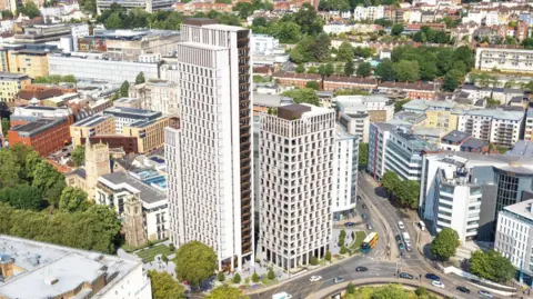 Olympian Homes CGI image of two tower blocks surrounded by housing and roads in a city centre.