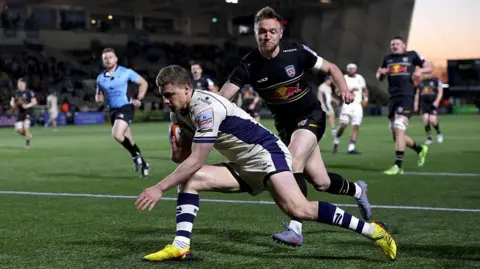 Noah Heward about to touch down to score Bristol's fourth try as a Newcastle player tries to get near him 