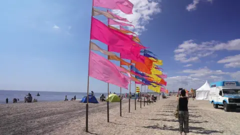 Richard Knights/BBC Flats are placed in a line at First Light Festival on Lowestoft beach.