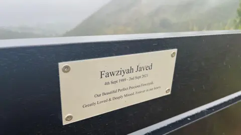 BBC/Steven Godden A plaque showing Fawziyah Javed's name on the memorial bench 