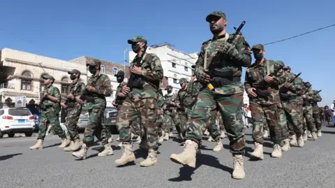 EPA Houthi fighters parade in Sanaa, Yemen (18 December 2024)