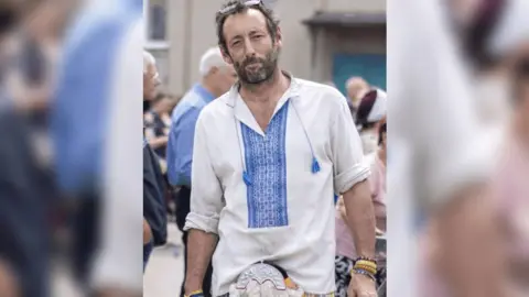 Tom Hughes Tom Hughes in a blue and white shirt