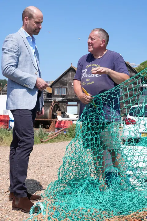 Gareth Fuller / PA Wire Prince William meets fisherman Steve Gurka in the Old Town. Steve is holding a green fishing net
