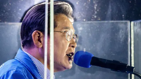 Lee, who survived an assassination attempt in 2024, now campaigns behind bulletproof glass and wears a bulletproof vest