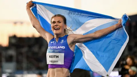 Megan Keith of Scotland celebrates finishing in third place following the Women's 5,000m Final on day seven of the Glasgow 2026 Commonwealth Games at Scotstoun Stadium on July 30, 2026 in Glasgow